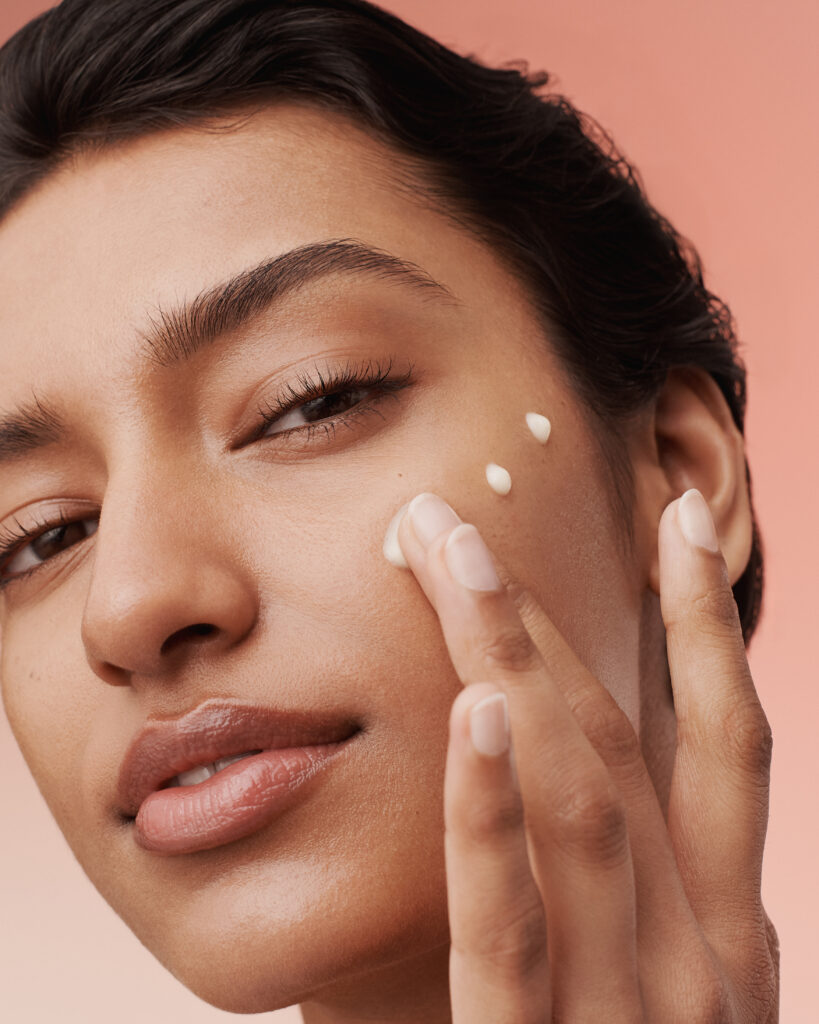 Woman applying skinbetter skincare cream to face